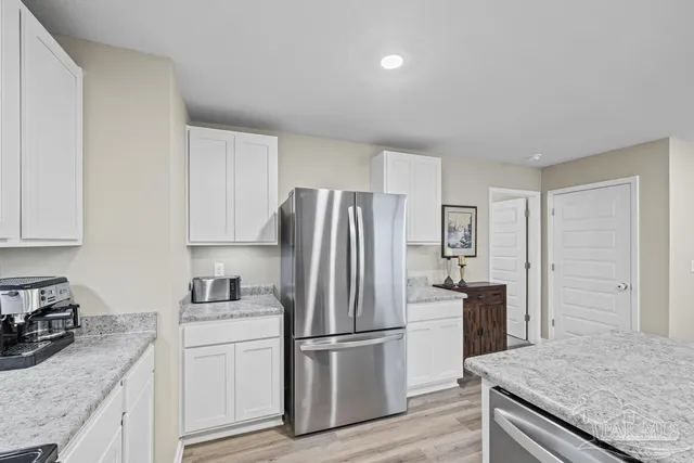 a kitchen with a refrigerator stove and sink