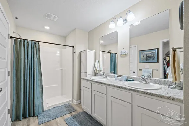 a bathroom with double sink and a mirror