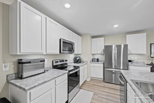 a kitchen with a sink stove and refrigerator