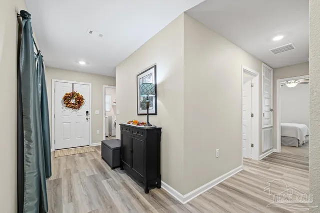 a view of a hallway view with wooden floor and staircase
