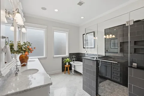 a bath tub sitting in a bathroom and mirror
