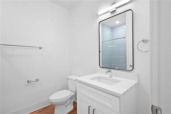 a bathroom with a sink toilet and mirror