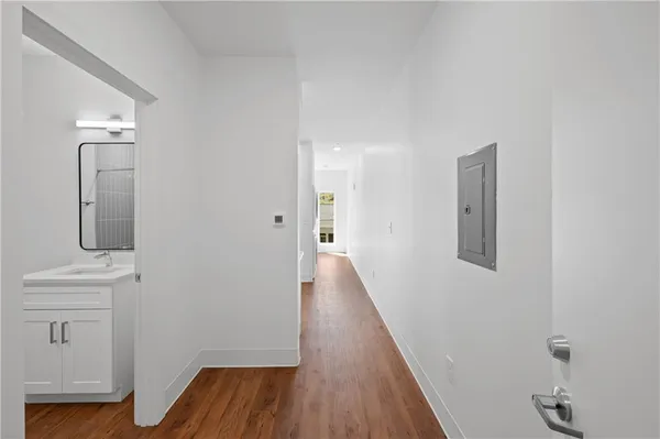 a view of hallway with wooden floor