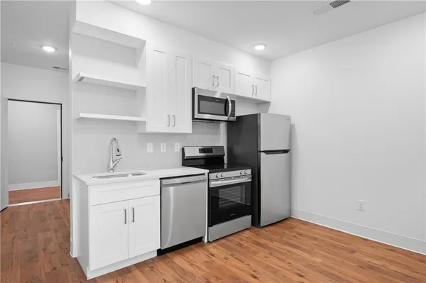 a kitchen with a sink a stove and refrigerator