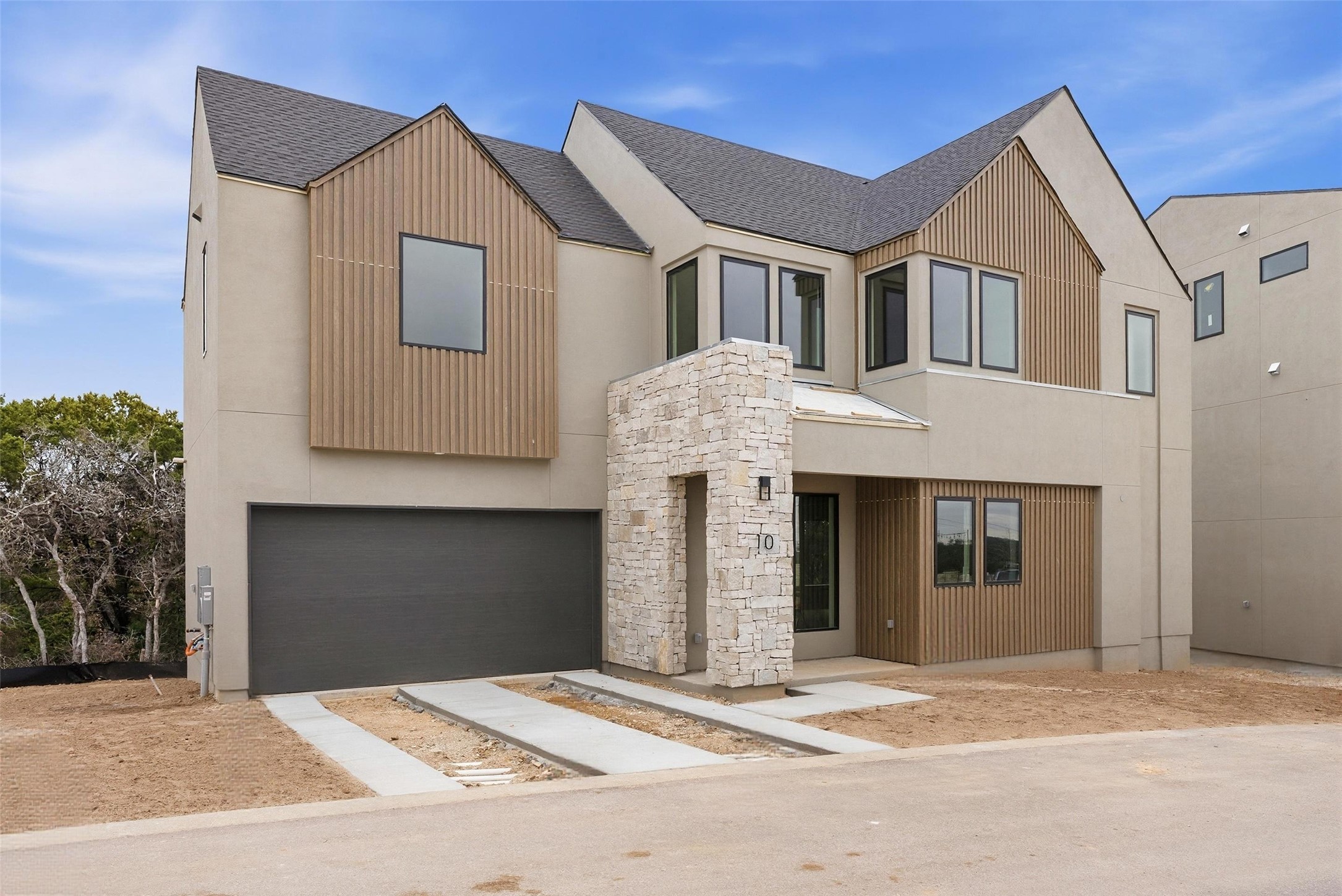 9803 Ribelin Ranch Court, Unit 10 Austin, TX 78750 - Photo 12 of 18 a front view of a house with a garage