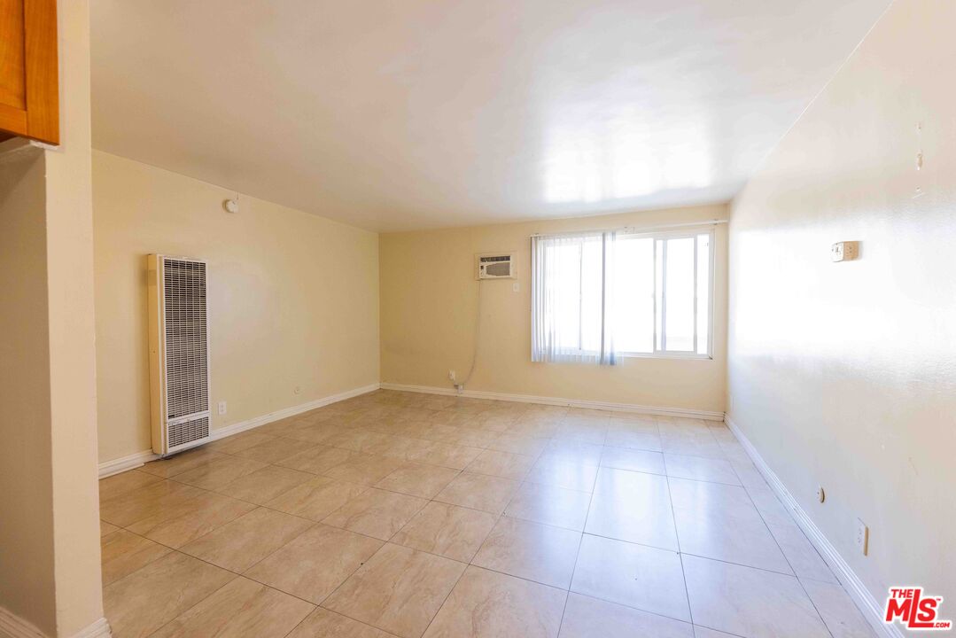 947 South Westmoreland Avenue, Unit 310 Los Angeles, CA 90006 - Photo 5 of 17 a view of an empty room with a window