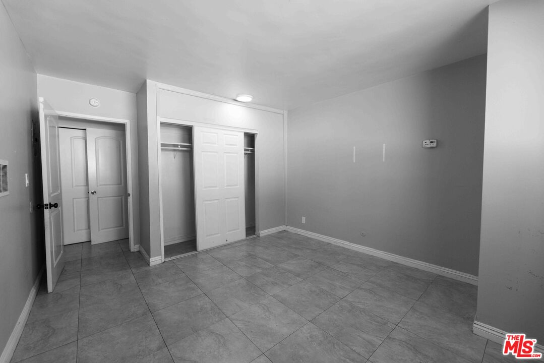 947 South Westmoreland Avenue, Unit 310 Los Angeles, CA 90006 - Photo 8 of 17 an empty room with closet and a bathroom