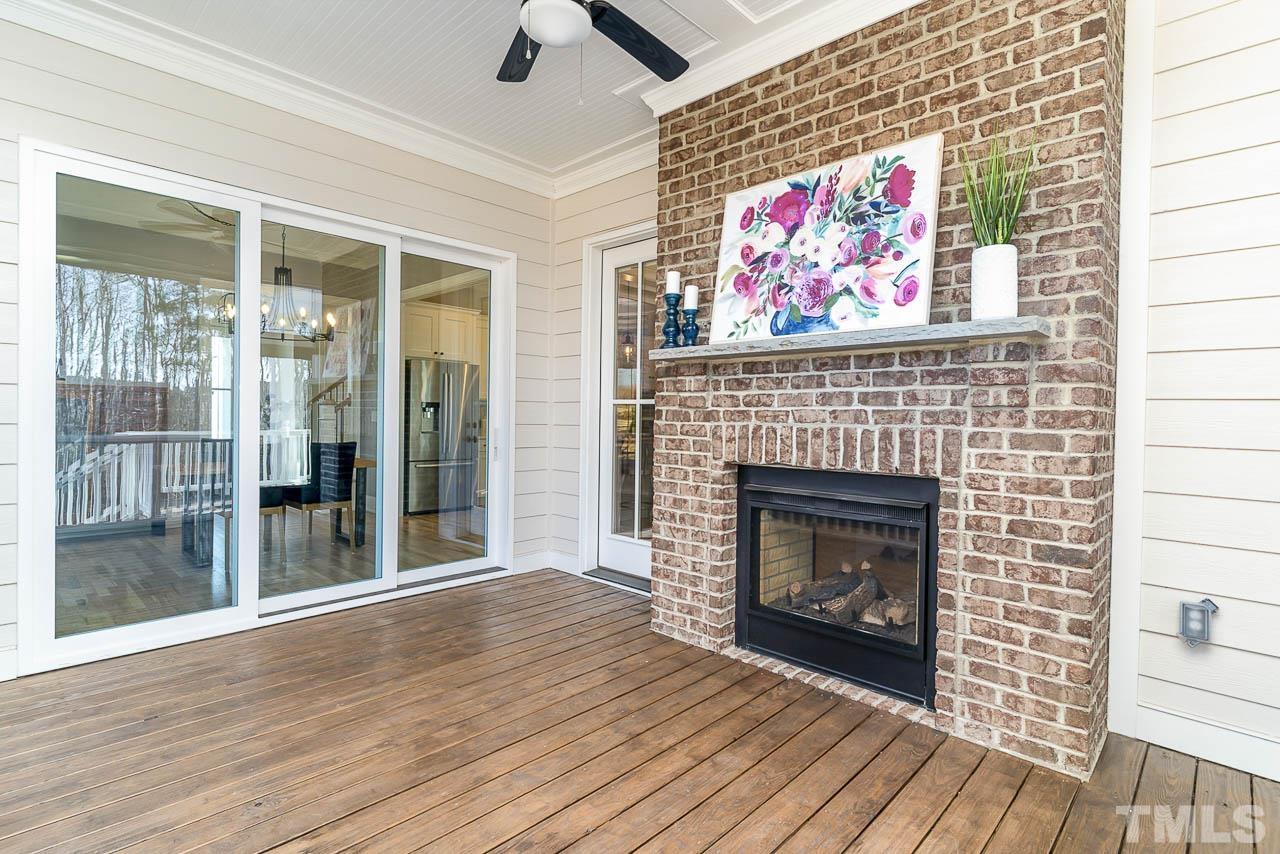 737 Daniel Rdg Road Wendell, NC 27591 - Photo 11 of 12 Cozy see through fireplace can be enjoyed from the living room or screened in porch.