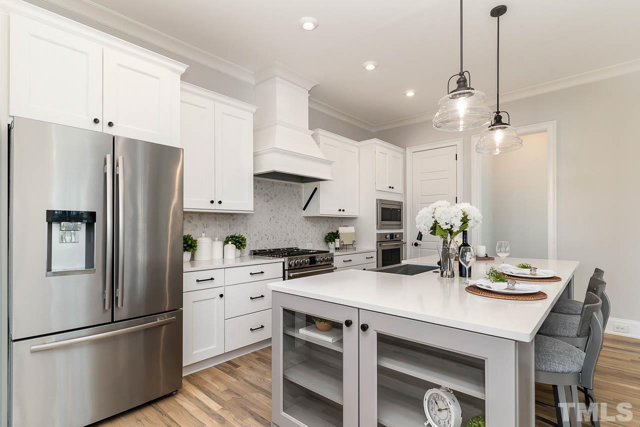 737 Daniel Rdg Road Wendell, NC 27591 - Photo 7 of 12 Bright kitchen with large island and stainless steel appliances
