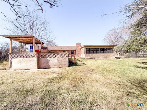 a front view of a building with a yard