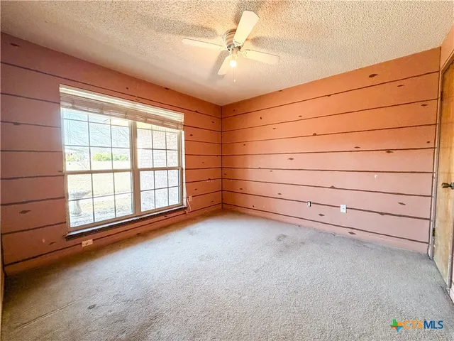 an empty room with a empty space and windows