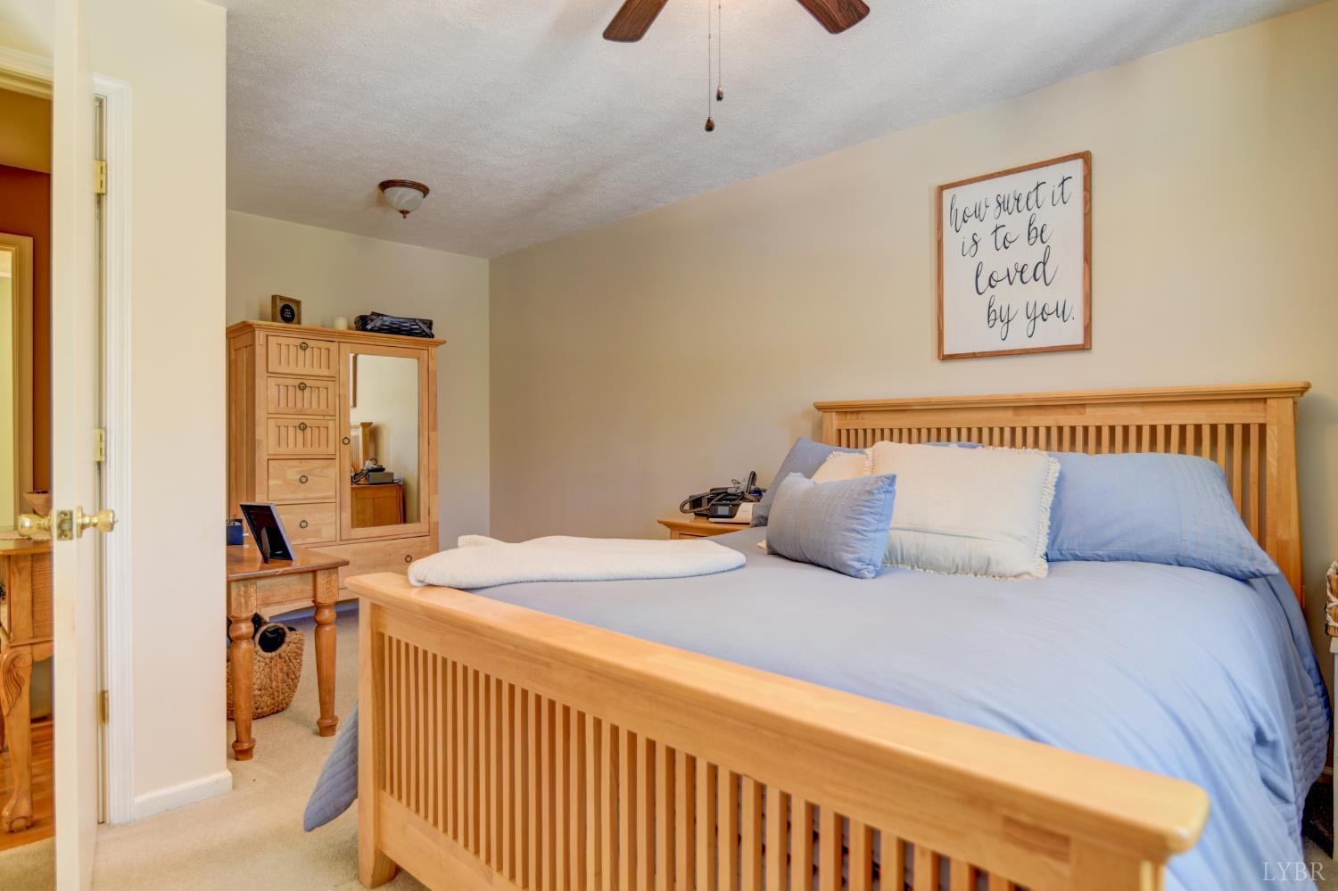 151 Anderson Place Rustburg, VA 24588 - Photo 20 of 57 a bedroom with a bed and wooden floor