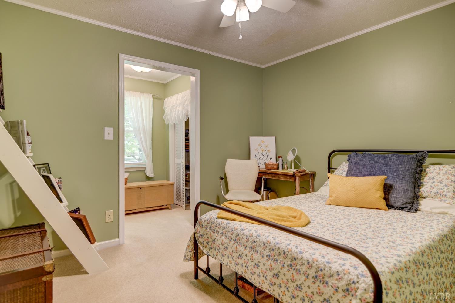 151 Anderson Place Rustburg, VA 24588 - Photo 21 of 57 a bedroom with a bed and a chandelier