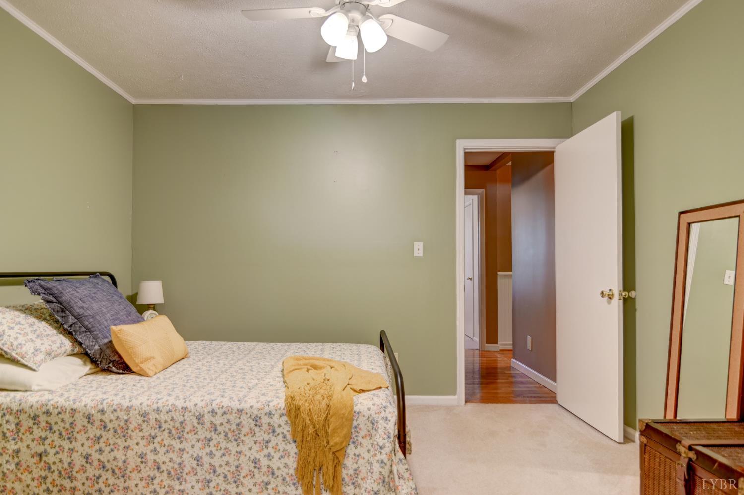 151 Anderson Place Rustburg, VA 24588 - Photo 23 of 57 a bedroom with a bed and a chandelier
