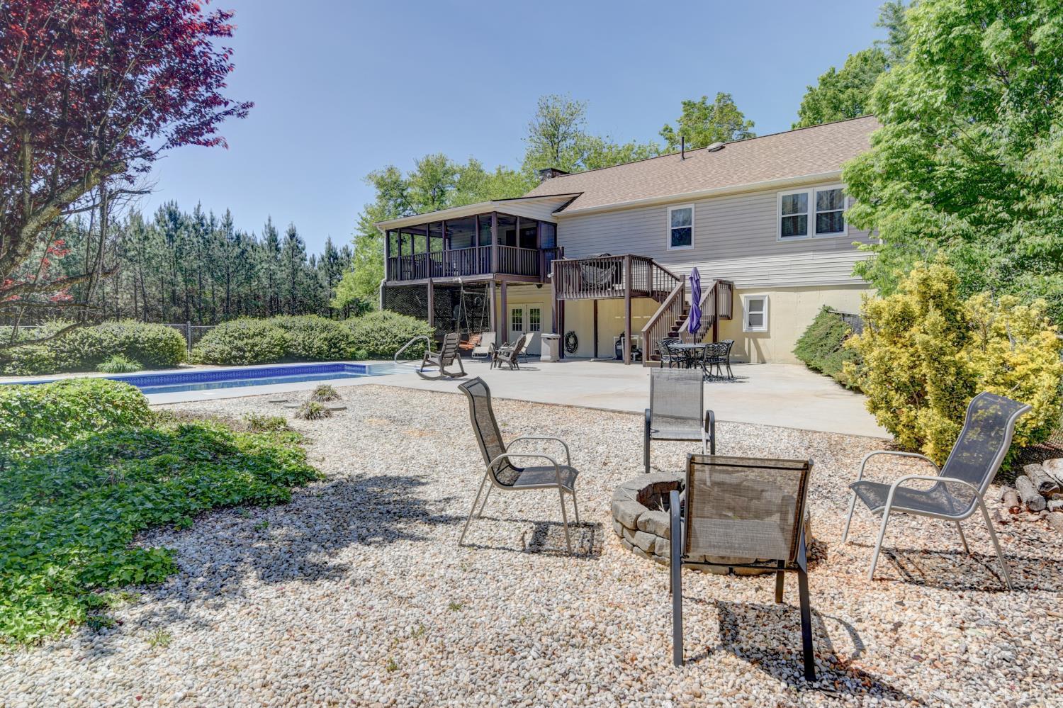 151 Anderson Place Rustburg, VA 24588 - Photo 43 of 57 a patio with sofas table and chairs with plants and trees