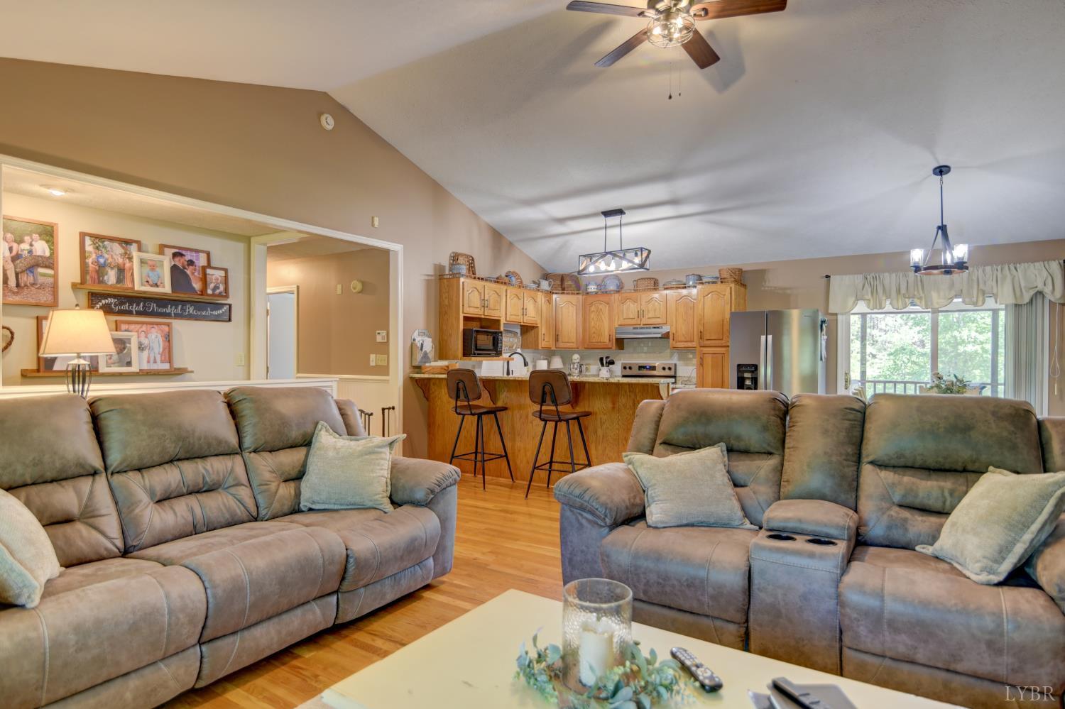 151 Anderson Place Rustburg, VA 24588 - Photo 56 of 57 a living room with furniture kitchen view and a chandelier