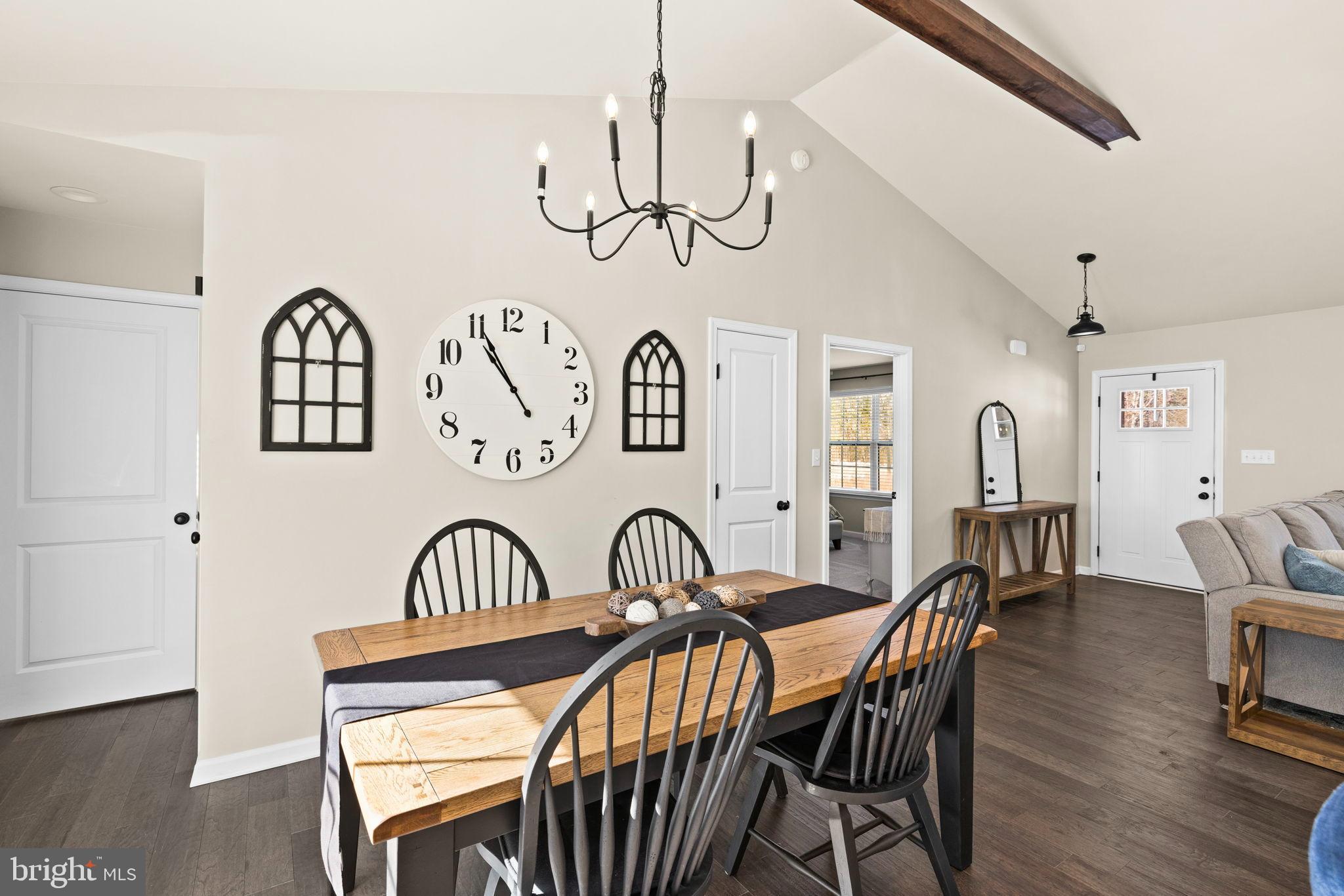 5269 Macedonia Road Woodford, VA 22580 - Photo 12 of 37 a view of a dining room with furniture a chandelier and wooden floor