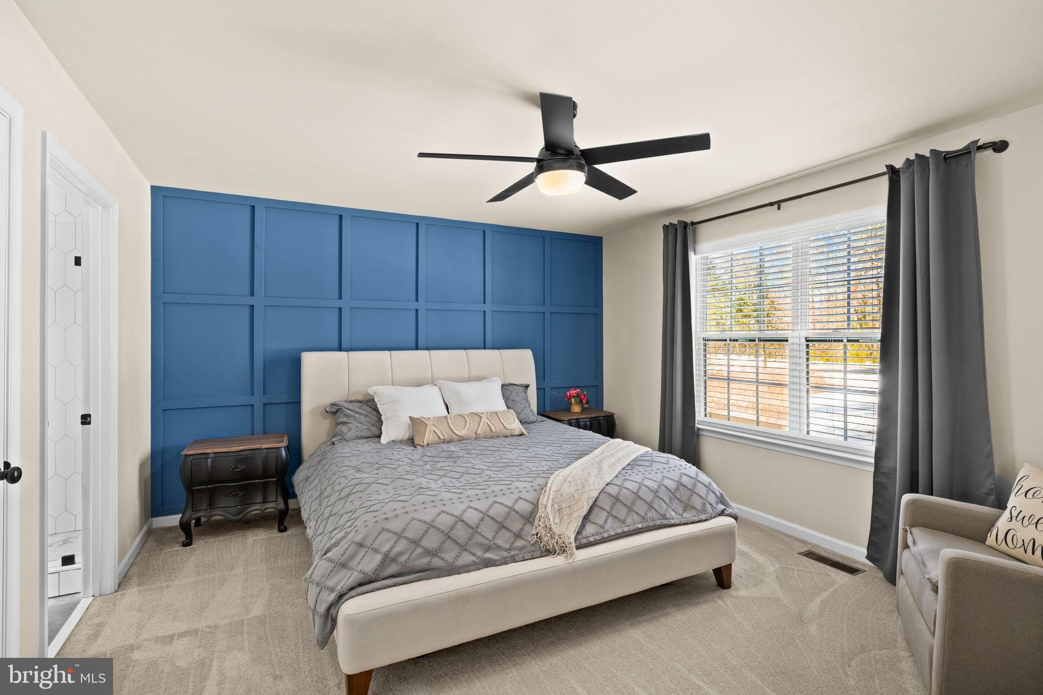 5269 Macedonia Road Woodford, VA 22580 - Photo 15 of 37 a bedroom with a large bed and a chandelier