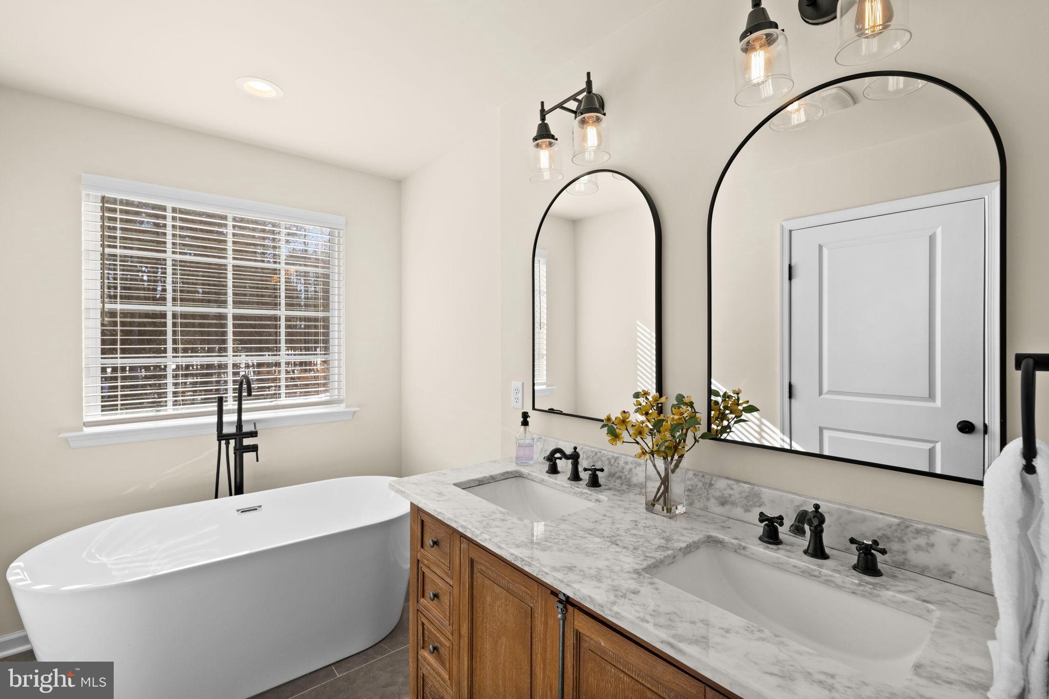 5269 Macedonia Road Woodford, VA 22580 - Photo 18 of 37 a bathroom with a granite countertop sink a large mirror and a window