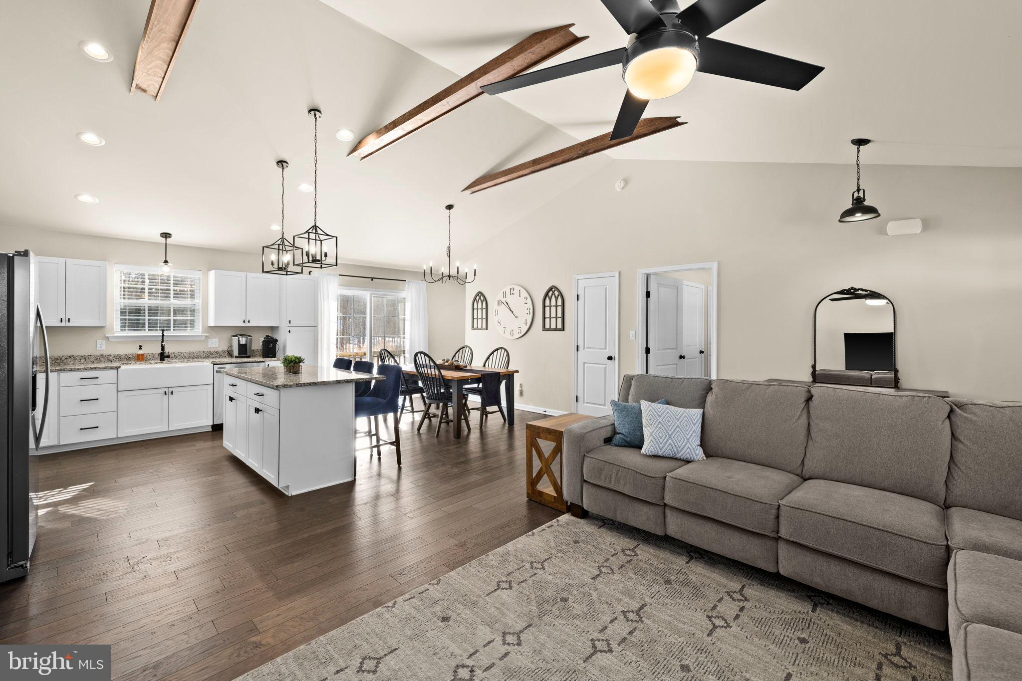 5269 Macedonia Road Woodford, VA 22580 - Photo 4 of 37 a living room with furniture kitchen view and a chandelier