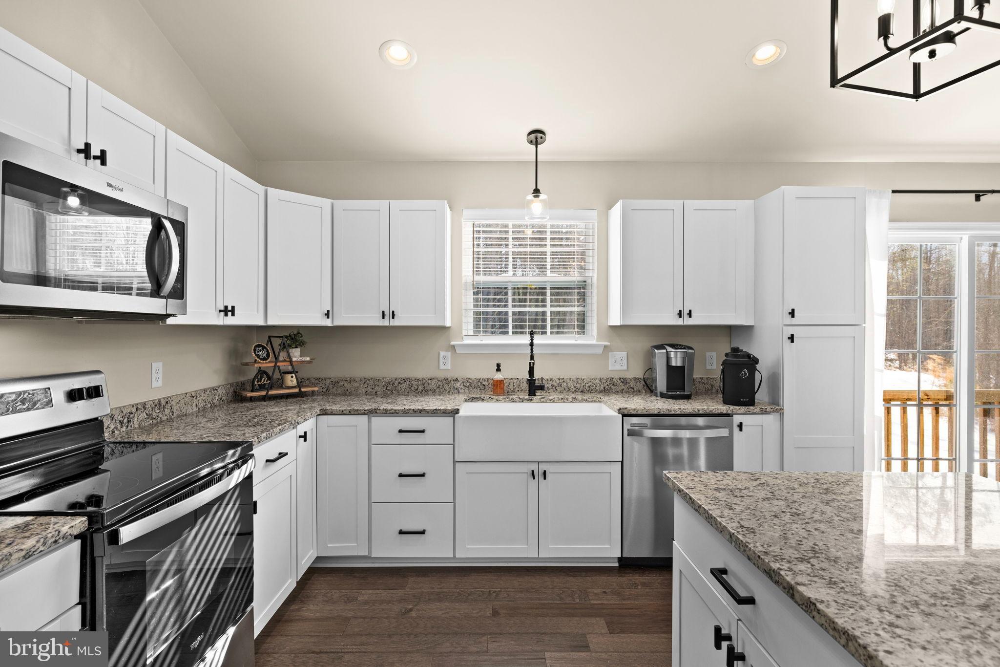5269 Macedonia Road Woodford, VA 22580 - Photo 6 of 37 a kitchen with stainless steel appliances granite countertop a sink stove and cabinets