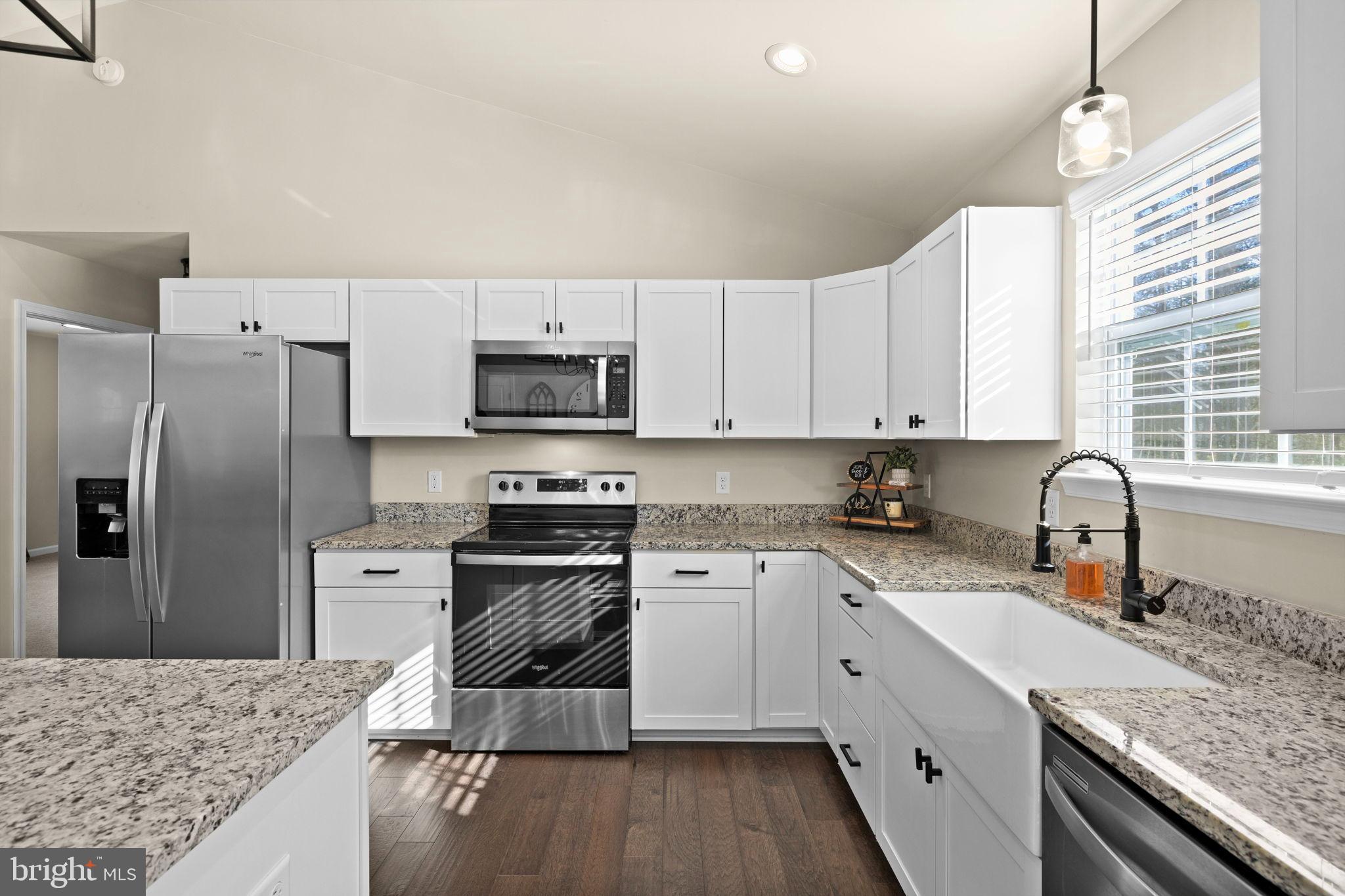 5269 Macedonia Road Woodford, VA 22580 - Photo 7 of 37 a kitchen with granite countertop a sink stove and refrigerator