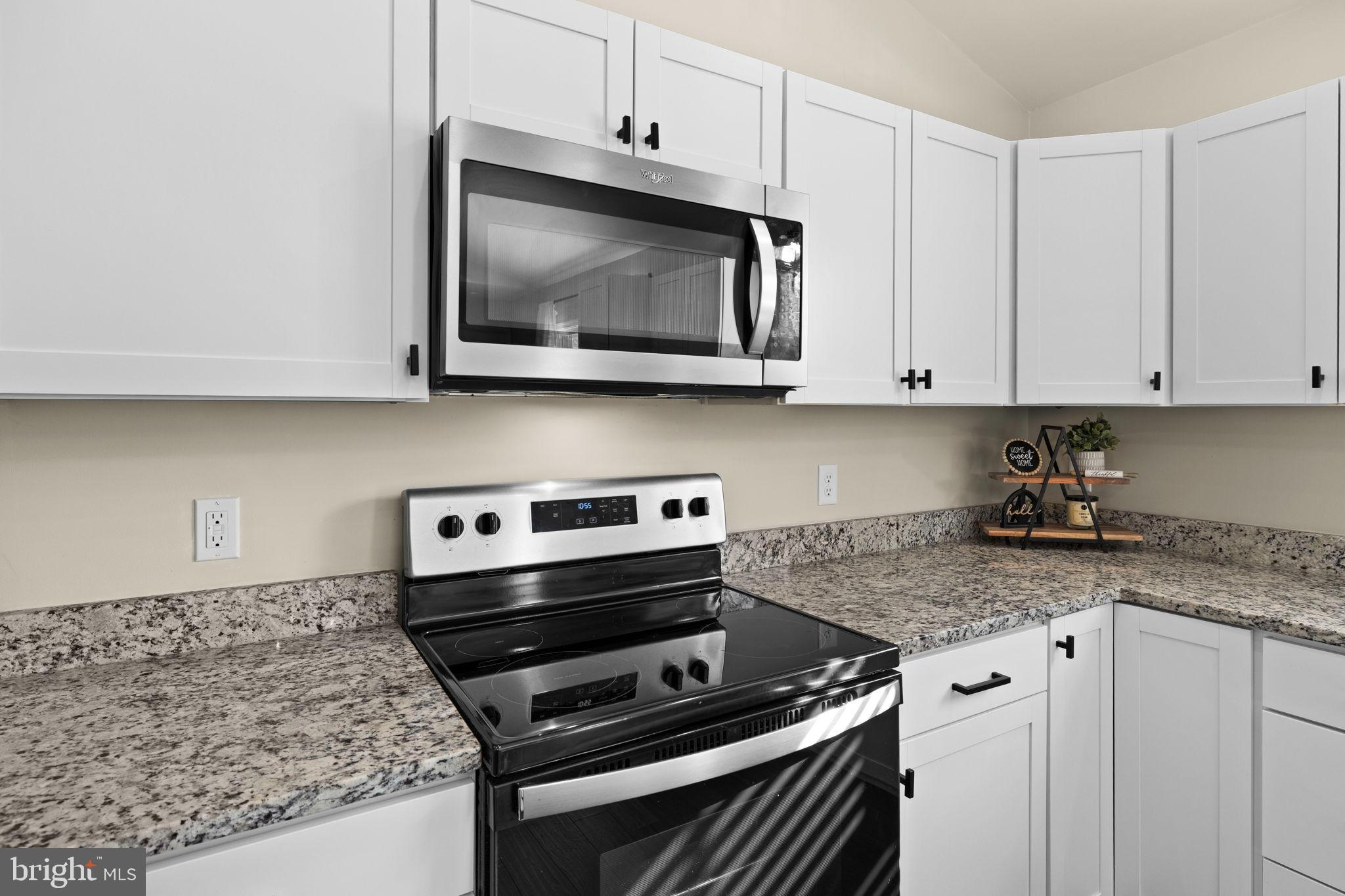 5269 Macedonia Road Woodford, VA 22580 - Photo 8 of 37 a kitchen with microwave cabinets and a stove top oven
