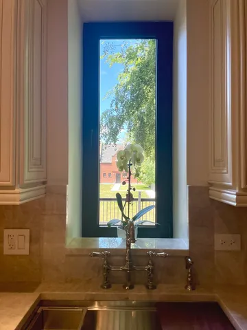 a view of a roof deck with couches under an umbrella