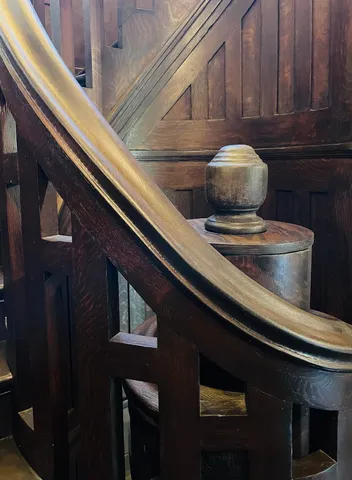 an empty room with wooden floor and cabinet