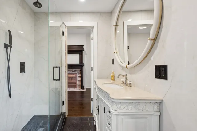 a kitchen with stainless steel appliances granite countertop a refrigerator stove and white cabinets