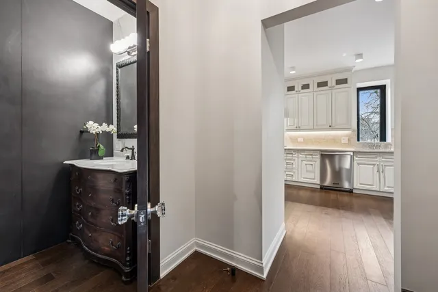 a kitchen with granite countertop a refrigerator and a stove top oven