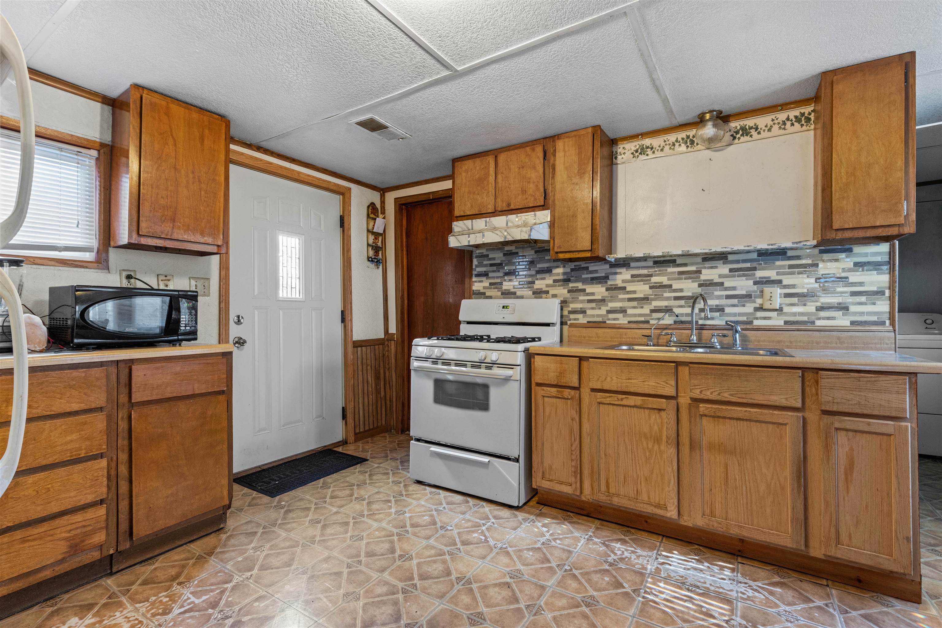 120 5th Street Capron, IL 61012 - Photo 5 of 13 a kitchen with stainless steel appliances granite countertop a sink and cabinets