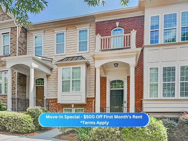 front view of a brick house with large windows
