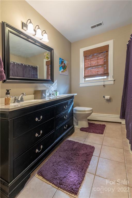 7680 Rhodhiss Road Connelly Springs, NC 28612 - Photo 12 of 25 a bathroom with a toilet sink and mirror