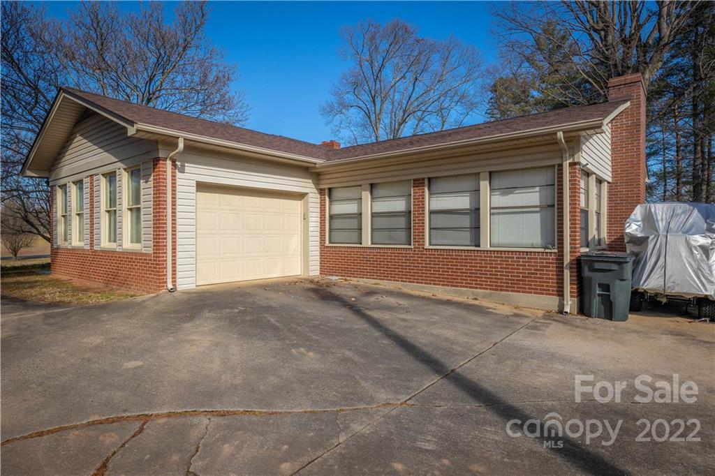 7680 Rhodhiss Road Connelly Springs, NC 28612 - Photo 19 of 25 a view of house with backyard and trees in the background