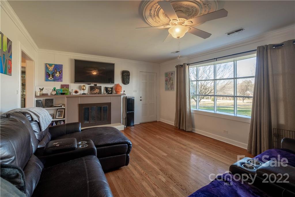7680 Rhodhiss Road Connelly Springs, NC 28612 - Photo 3 of 25 a living room with furniture a flat screen tv and a fireplace