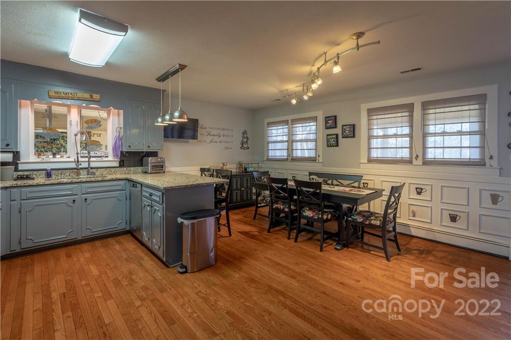 7680 Rhodhiss Road Connelly Springs, NC 28612 - Photo 6 of 25 a kitchen with lots of counter top space and dining table