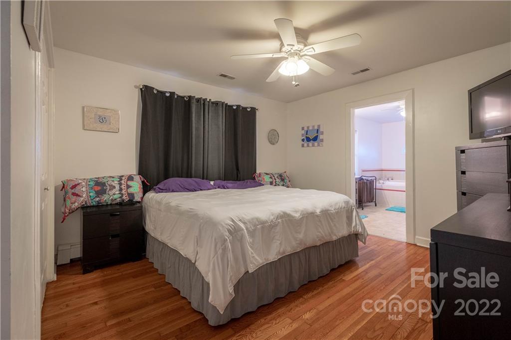 7680 Rhodhiss Road Connelly Springs, NC 28612 - Photo 8 of 25 a bedroom with a bed and a chandelier