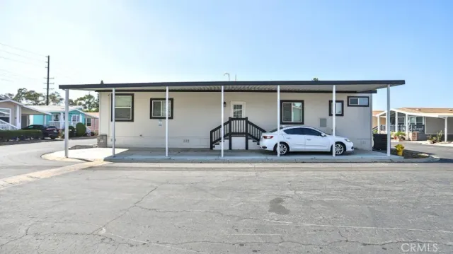 a view of a house with backyard and sitting area