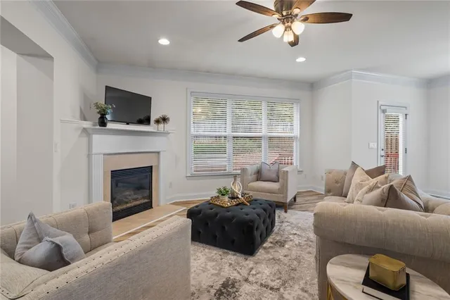 a living room with furniture a fireplace and a flat screen tv