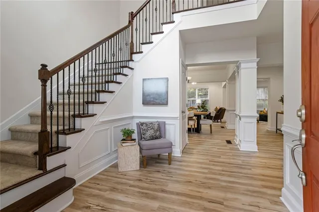 a view of entryway and hall with wooden floor