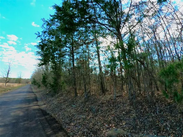 a street sign that is sitting on a brick wall