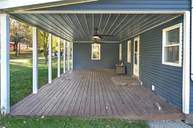 a view of backyard with a wooden deck