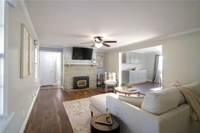 a living room with furniture a fireplace and a flat screen tv