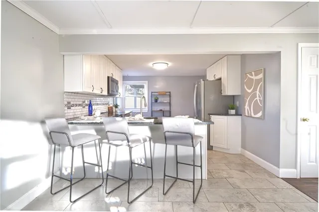 a dining room with furniture and window