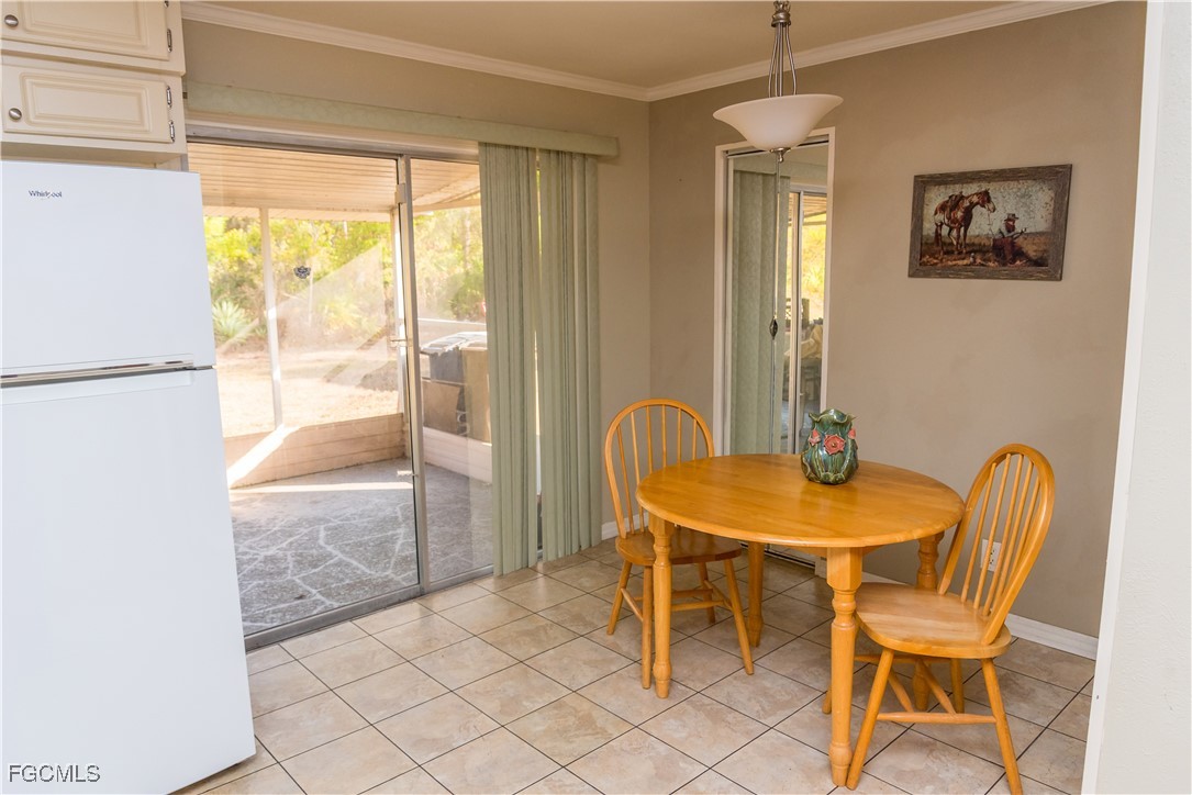4103 East 10th Street Lehigh Acres, FL 33972 - Photo 8 of 16 a dining room with furniture and window