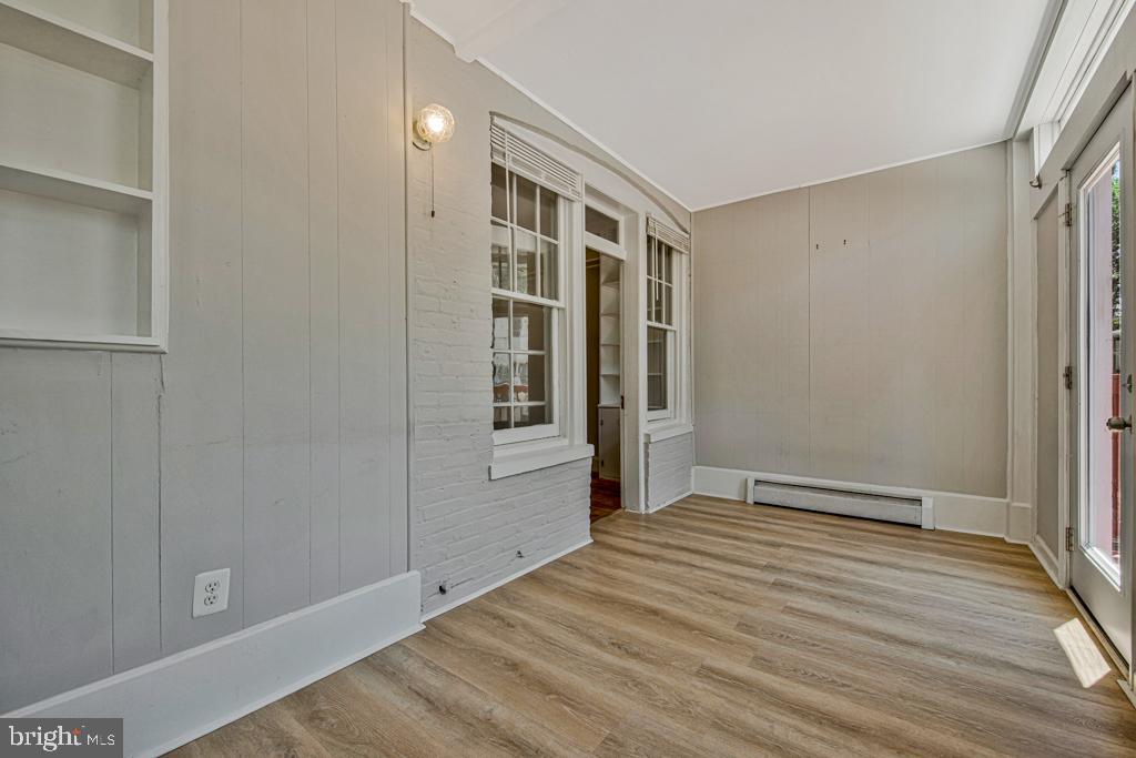 2406 37th Street Northwest Washington, DC 20007 - Photo 21 of 44 a view of an empty room with wooden floor and a window