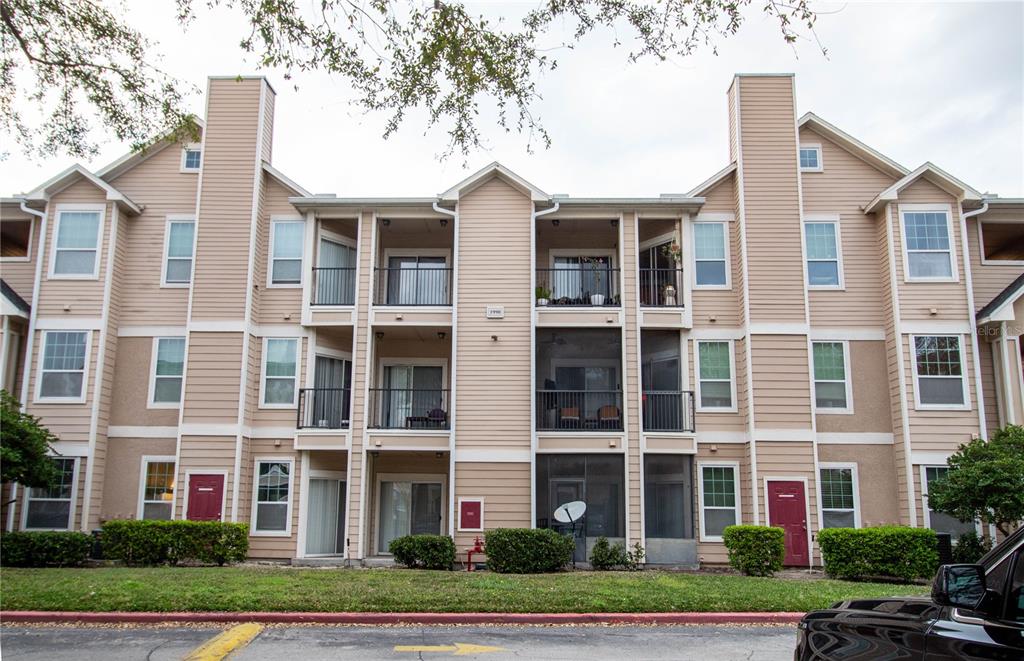 1990 Erving Circle, Unit 207 Ocoee, FL 34761 - Photo 1 of 1 front view of a brick building next to a yard