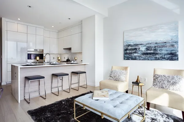 a living room with stainless steel appliances kitchen island granite countertop furniture and a view of kitchen