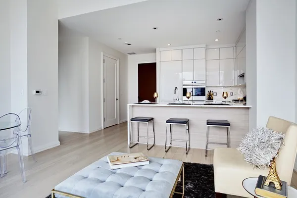 a kitchen with kitchen island granite countertop a sink and cabinets
